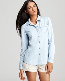 Fashioned in ultra-soft chambray, this Volcom shirt borrows from the boys without losing its feminine edge.