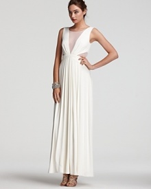 Sheer inserts at the neckline and waist reveal subtle hints of skin on this hypermodern yet elegant BCBGMAXAZRIA gown.