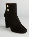 These commanding booties spell sophistication; metallic, military inspired buttons add some dash; from kate spade new york.