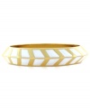 A bold direction. Vince Camuto's bangle bracelet is crafted from gold-tone mixed metal with ivory enamel making up a stylish chevron pattern for added appeal. Approximate length: 8-1/2 inches.