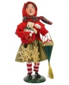 A young girl helps with the holiday shopping, picking up traditional straw ornaments, a teddy bear and treats in this handcrafted figurine from Byers' Choice.