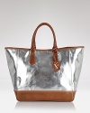 Furla puts a silvery spin on the classic tote with a metallic sheen and cool, contrast rubber bottom. In a practical shape, this bag shines during the day.