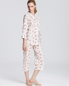 Lounge around in style with this classic three-quarter sleeve top and capri pajama pants featuring a pretty floral print.