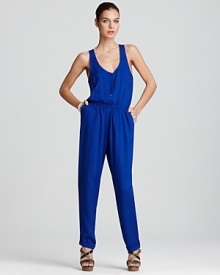 Aqua showcases a versatile jumpsuit in a carefree silhouette. Accessorize this standout piece with an armful of bangles and a handbag in the season's favorite hue.