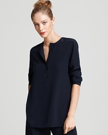 This Vince henley takes the casual style and puts a luxe spin on it, rendering the silhouette in lush silk, adding a back pleat and finishing with a rounded hem for a season of refined weekends.