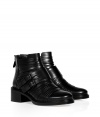 Rocker-chic looks get a decidedly luxe remix in Givenchys black leather ankle boots, complete with an ultra cool strappy buckled front and edgy chunky heel - Rounded toe, double buckled strap, back zip, stitched welt, stacked leather heel - Pair with modern cashmere dresses or favorite skinnies and chunky knits