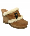 Luxe texture is layered with soft faux fur and stacked upon a chic clog silhouette with these comfy Edgewater clogs by Lucky Brand. A horn tooth button embellishment lends a stylish, primitive edge.