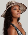 A chic two tone wide brim hat with zig-zag weave and ribbon trim makes a statement wherever you go.