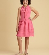 She'll want to play dress up in this charming frock of chiffon tiers, a sweet bow and full skirt.Jewel neckline with bowSleevelessSide zipperFull skirtPolyesterHand wash cold or dry cleanImported