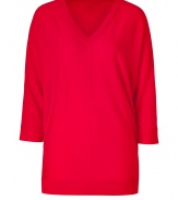 Paint bright color into your chic knitwear collection with DKNYs radiant red pullover - V-neckline, 3/4 sleeves, front and back seams, fine ribbed trim - Long, lean fit - Wear with favorite skinnies with sleek ankle boots