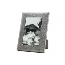 Supple shagreen-embossed fine Italian leather wraps this handcrafted frame in true luxury. A sturdy easel and easy access to photos makes it equal parts form and function. Supple shagreen-embossed fine Italian leather wraps this handcrafted frame in true luxury. A sturdy easel and easy access to photos makes it equal parts form and function.