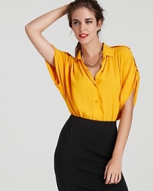 With epaulets and rolled and tabbed sleeves, this golden DIANE von FURSTENBERG top boasts military-inspired style for chic juxtaposition with a timeless pencil skirt. A gilded necklace tops off the look with the perfect dose of glam.