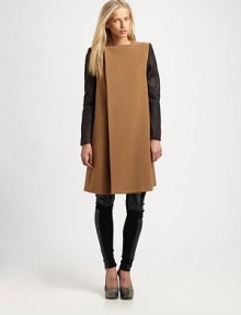 This dynamic silhouette boasts a clean, asymmetric-front offset by rich, leather-like sleeves for the perfect mix of minimalist and contemporary edge.JewelneckConcealed three-button frontContrast sleevesOn-seam slash pocketsSwing backAbout 40 from shoulder to hemPolyesterDry cleanImportedModel shown is 5'8½ (174cm) wearing US size Small.