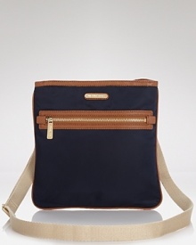 Champion practical (and portable) style with this slim nylon crossbody from MICHAEL Michael Kors, sure to add on-the-go ease to every look. Champion practical (and portable) style with this slim nylon crossbody from MICHAEL Michael Kors, sure to add on-the-go ease to every look.