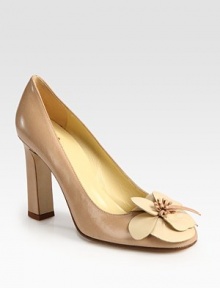 Lady-like leather silhouette with a chunky heel and contrasting flower embellishment. Self-covered heel, 4 (100mm)Leather upperLeather lining and solePadded insoleImportedOUR FIT MODEL RECOMMENDS ordering one half size down as this style runs large. 