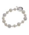 Add elegant inspiration with a sophisticated bracelet by Carolee. Crafted in mixed metal with toggle clasp, bracelet features glass pearls and crystal fireballs. Approximate length: 7-1/4 inches.