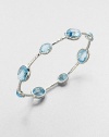 From the Rock Candy Collection. A graceful bangle of sculptural sterling silver is dotted with richly faceted ovals of dinsinctively hued blue topaz.Blue topazSterling silverDiameter, about 2.6Imported