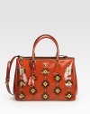 Polished Italian spazzolato leather with floral patchwork detail in a structured tote silhouette.Double top handles, 5 dropAdjustable shoulder strap, 17-19 dropZip closureTwo inside zip compartmentsOne inside zip pocketThree inside open pocketsProtective metal feetFully linedLeather14W x 9H x 6DMade in Italy