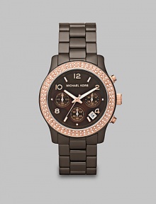 A brilliant timepiece with a peach crystal accented bezel, rose goldtone stainless steel details and espresso ceramic link bracelet. Quartz movementWater resistant to 5 ATMRound espresso ceramic case, 39mm (1.5)Light peach crystal bezelBrown chronograph dialNumeric and bar hour markersDate display between 4 and 5 o'clockSecond hand Espresso ceramic link braceletImported A brilliant timepiece with a peach crystal accented bezel, rose goldtone stainless steel details and espresso ceramic link bracelet. Quartz movementWater resistant to 5 ATMRound espresso ceramic case, 39mm (1.5)Light peach crystal bezelBrown chronograph dialNumeric and bar hour markersDate display between 4 and 5 o'clockSecond hand Espresso ceramic link braceletImported