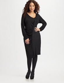 An unique design awash in details. Asymmetrical V-neck Long sleeves with ruched cuffs Silver dotted shoulder details Ruched center front and back seams About 25½ from natural waist 95% viscose/5% spandex Hand wash Imported 