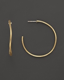 Large, undulating hoops of beautifully textured 18K yellow gold from the Jaipur collection by Marco Bicego.