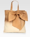 Supple Italian leather in a trend-smart ombré design with double top handles and an oversized bow adornment. Double top handles, 6¾ dropMagnetic snap closureOne inside zip pocketCotton lining14W X 14¼H X 2DMade in Italy
