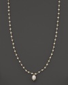 An iridescent freshwater pearl necklace with center pearl drop.