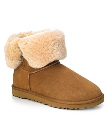 UGG® Australia suede ankle boots with genuine shearling lining will keep your feet in ultimate comfort. Shearling cuff can be worn up or down for a more versatile look. Functional elastic loop and button at side and rubber wafer sole.