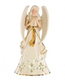 An ethereal figure draped in ivory and gold, this porcelain angel from Lenox is a beacon of hope throughout the holidays. Pierced accents reveal a light from within. An ethereal figure draped in ivory and gold, this porcelain angel from Lenox is a beacon of hope throughout the holidays. Pierced accents reveal a light from within.