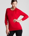 Embrace classic femininity in a richly-hued DKNY sweater, finished with a generous bow collar for retro charm.