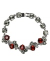 Code red. Stunning Siam and black glass accents are presented perfectly on Givenchy's fashionable flex bracelet. Set in hematite tone mixed metal, it's an alluring accent for day or evening. Approximate length: 7-1/4 inches.