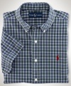 Cut for a relaxed, classic fit, a short-sleeved sport shirt is crafted from crisp cotton poplin in traditional tartan plaid for an authentic look.