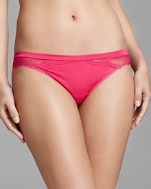 A stunning thong with sheer scalloped lace trim that accentuates the hips and legs, a subtle, yet dramatic effect.