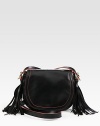 Butter-smooth leather in a classic saddle silhouette, finished with contrast trim and dual side tassels.Shoulder strap, 23 dropFlap snap closureOne inside open pocketCotton lining8¼W X 7½H X 1½DImported