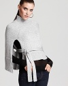 This BCBGMAXAZRIA capelet takes on the season's chicest trend in chic style. The perfect topper on laid-back weekends, the ultra soft piece polishes your every look.