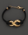 An elegant chain bracelet with an edgy appeal combing 18 Kt. gold and black leather.