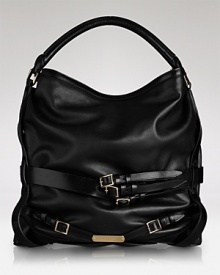 Chic straps help this leather Burberry tote ease from day to evening in sleek style. Chic straps help this leather Burberry tote ease from day to evening in sleek style.