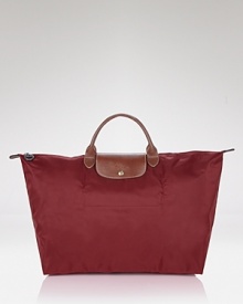 With durable leather trim and a fold-up body, Longchamp's top handle tote is a jaunt-setters necessity. Whether tarmac or terminal, carry it for an easy-chic takeoff.