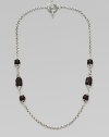 From the Iris Collection. Carved matte black onyx beads punctuate this sterling silver chain link style. Sterling silver Toggle closure Length, about 18 Imported 