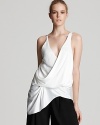 With a wrapped v neck and a relaxed silhouette, this Helmut Lang tank lends high-style to your favorite wardrobe basics.