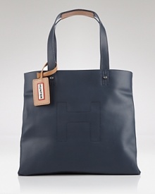 Inspired by their iconic boots, Hunter's rubber tote has a distinctly practical design. With a roomy interior and leather trims, this bag is a go-anywhere style that's chic rain or shine. Inspired by their iconic boots, Hunter's rubber tote has a distinctly practical design. With a roomy interior and leather trims, this bag is a go-anywhere style that's chic rain or shine.