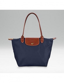 Pliage nylon signature tote, great for travel as well as everyday use. Top zip plus leather top handle, shoulder drop, 7½ Snap flap Inside pocket Folds up and snaps closed Opens to 9¾W X 9¾H x 5½D Imported Pliage nylon signature tote, great for travel as well as everyday use. Top zip plus leather top handle, shoulder drop, 7½ Snap flap Inside pocket Folds up and snaps closed Opens to 9¾W X 9¾H x 5½D Imported