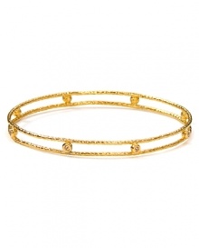 Embrace the season's eclectic approach to accessorizing with this hammered gold-plated bangle from Melinda Maria, adorned with striking champagne-colored stones.