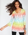 Mini studs at the sleeves and front of INC's tie-dye print tunic give this look a subtle shine and extra edge.