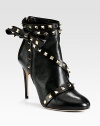 Balance masculine and feminine wearing this on-trend leather ankle boot, topped with edgy metal studs and a dimensional side bow. Self-covered heel, 4¼ (110mm)Leather upper with metal studsBack zipLeather lining and solePadded insoleMade in Italy