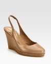Classically fashionable wardrobe favorite of lustrous patent leather on an elevated wedge and platform. Patent leather wedge, 3¾ (95mm)Patent leather platform, ¾ (20mm)Compares to a 3 heel (75mm)Patent leather upperLeather lining and solePadded insoleImportedOUR FIT MODEL RECOMMENDS ordering one half size up as this style runs small. 