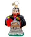 Get sucked into the Halloween spirit with a vampire smiling back from the grave. The blood-red lining of his cape and sparkling glitter detail are all part of the fun in an ornament handcrafted by Christopher Radko.