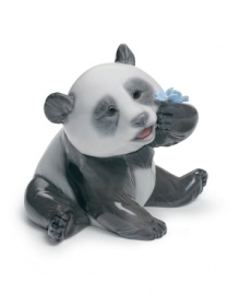 What a bear. This giant panda figurine inspects the intricate folds of a porcelain flower in this exquisitely handcrafted Lladro figurine. What a bear. This giant panda figurine inspects the intricate folds of a porcelain flower in this exquisitely handcrafted Lladro figurine.