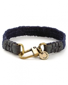 Leather and brasstone hardware bring a city edge to this canvas bracelet from Caputo. Leather and brasstone hardware bring a city edge to this canvas bracelet from Caputo.