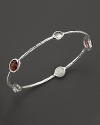 Cinnamon gemstone doublets of color backed mother-of-pearl and hand-faceted clear quartz set in sterling silver. From Ippolita.